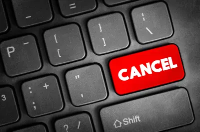 Computer keyboard with a red “Cancel” key.