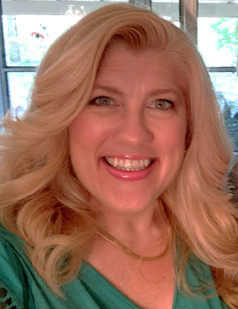 Headshot of a woman with blonde hair and a green shirt.