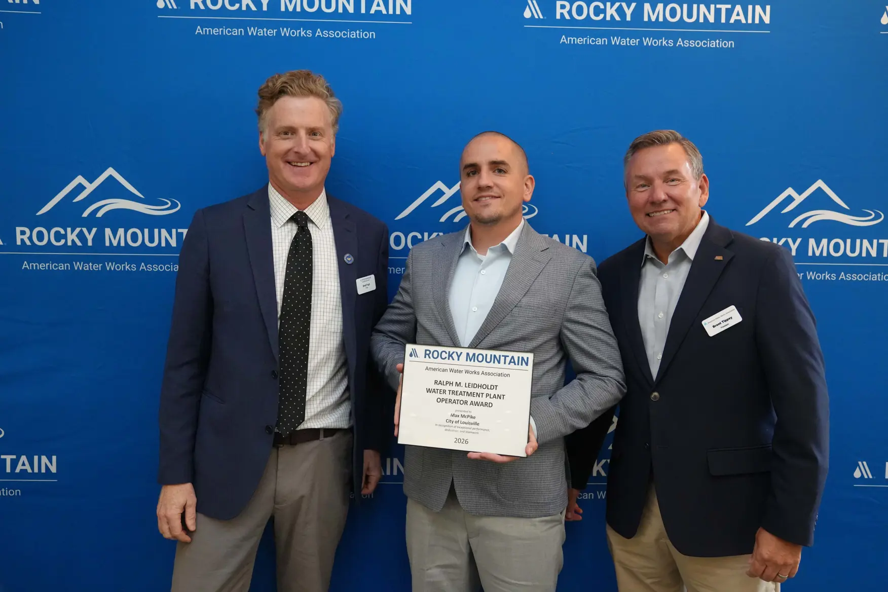 Louisville water treatment plant operator Max McPike holding an award with officials at the 2026 Rocky Mountain Water Conference