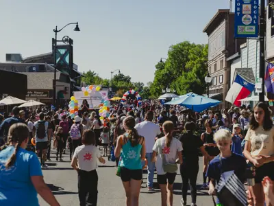 A large group of people on a city street in a parade.